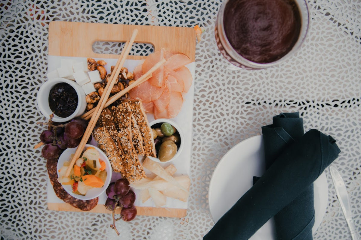 Fresh fish, pastry, olives, dip and fruit on the side